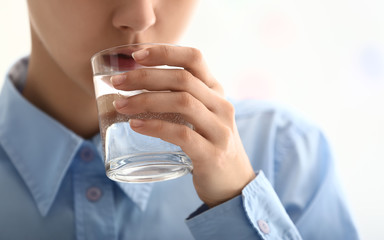 Woman drinking water, closeup