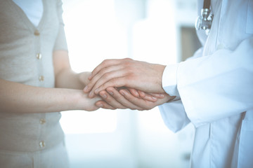 Hand of doctor reassuring her female patient. Medicine and health care concept