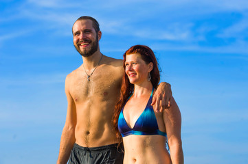 Fototapeta premium happy and beautiful couple enjoying Summer holidays travel or honeymoon trip together in tropical paradise beach having fun relaxed and playful on the sea