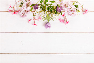 Festive flower composition on the white wooden background. Overhead view