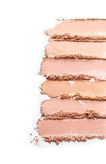 Samples of facial powder on white background