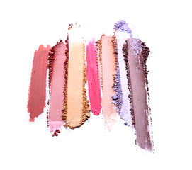 Samples of cosmetic powder on white background