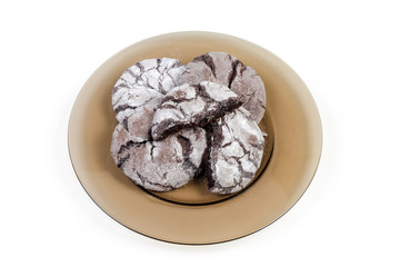 Round brownie cookies on dish on a white background