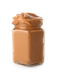 Jar with peanut butter on white background