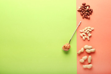 Obraz na płótnie Canvas Tasty peanut butter with nuts on color background