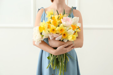 Obraz na płótnie Canvas Woman with bouquet of beautiful flowers on white background