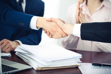 Business people shaking hands finishing up a meeting. Handshake at successful negotiation