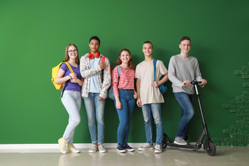 Group of teenagers near color wall