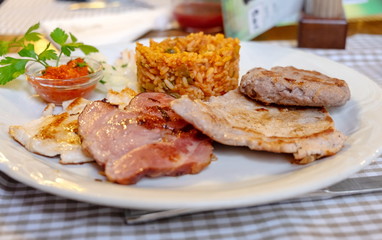 Assorted fried meats (chicken, lamb, beef) and fried rice, served at restaurant