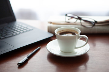 Newspaper with computer on table. Coffee break. 