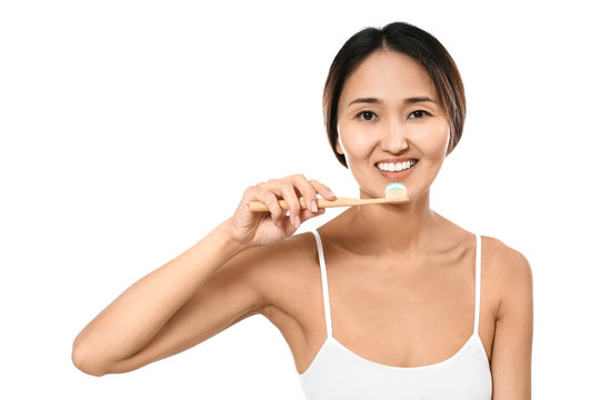 Asian Woman Brushing Teeth On White Background