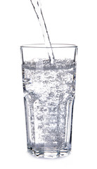 Pouring of water into glass on white background