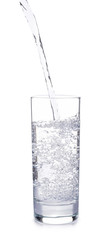 Pouring of water into glass on white background