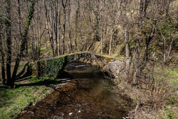 le petit pont de pierre enjambe la rivière