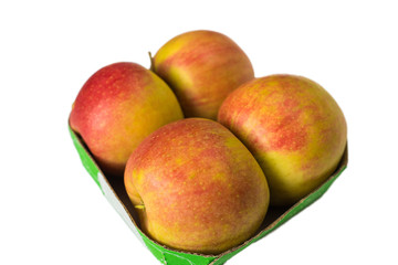 Four large ripe apples per package on a white background.