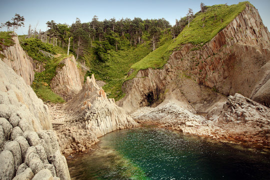 Cape Stolbchaty, geographic cape on the east shore of Kunashir Island of Sakhalin Oblast, Russia. Composed of layers of basaltic lavas of the Mendeleyev volcano.