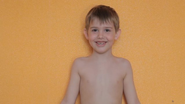 the boy takes off his shirt
