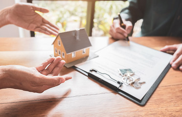 Car and House model with agent and customer discussing for contract to buy, get insurance or loan real estate or property background.