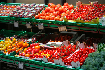 Unpacked, fresh assortment of tomatoes in a self-service supermarket.
