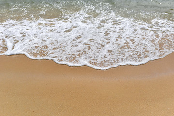 Fototapeta na wymiar Soft motion waves on the sandy beach