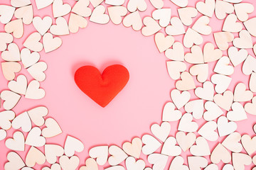 Wood hearts on pink background have a gift box,