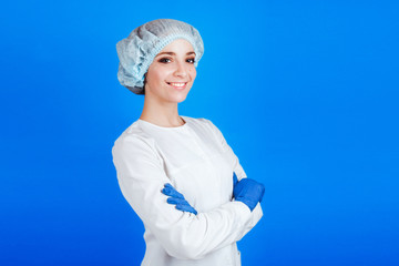 A young female doctor in white clothes on a blue background