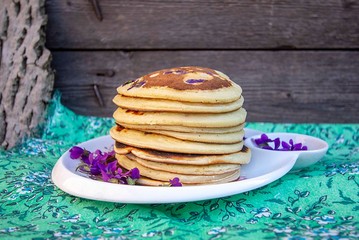 homemade pancakes with vets of violets in the shape of a heart