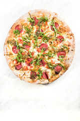 Pepperoni pizza with fresh arugula