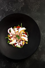 Fresh salad.Concept for a tasty and healthy meal. Dark stone background.
