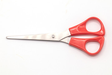 Red scissor on isolated white background.