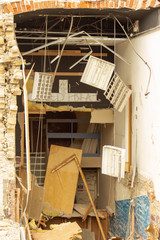 A glimpse into a former office building through a demolished wall