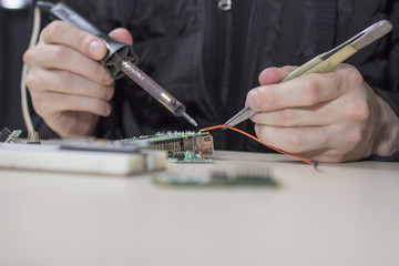 a man soldering parts
