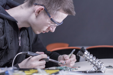 a man soldering parts