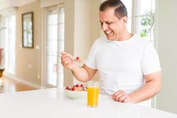 Middle age senior man eating healthy cereals for breakfast