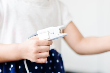 Fingertip Pulse Oximeter on finger of little baby child in hospital