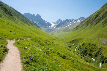 Naklejka premium Kazbegi, Georgia - Jul 03 2018: Juta valley near Caucasus mountain. a famous landscape in Kazbegi, Mtskheta-Mtianeti, Georgia.