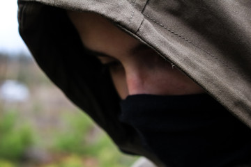 face of a guy in a black mask and hood close up