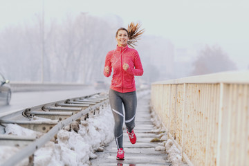 Beautiful fitness woman enjoying at winter morning. Winter fitness concept.