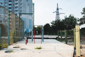 children's playground with swings in courtyard of residential building in the city
