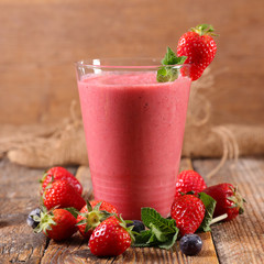 berry fruit smoothie on wood background