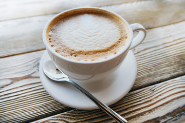 cup of coffee on wooden table