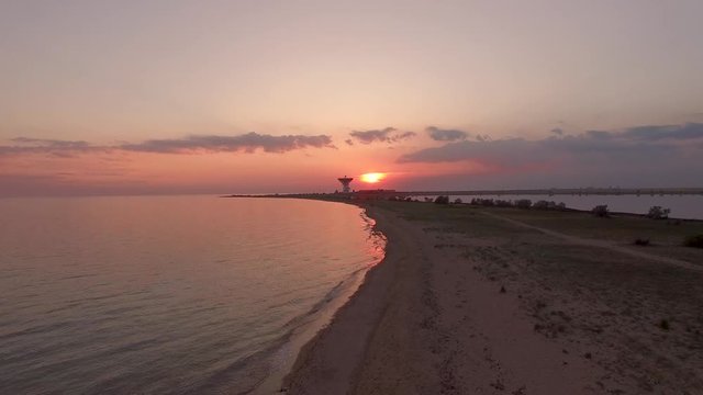 Red sunset on the beach against the background of a space antenna. Evpatoria, Crimea.