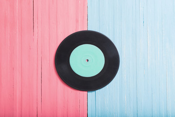 Music records on pink and blue wooden background. Retro music concept