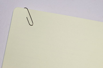 slanted  empty  paper note with paper clip   