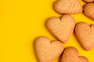 Heart-shaped cookies on yellow background