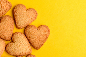 Homemade heart-shaped cookies on yellow