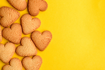 Heart-shaped cookies on yellow background