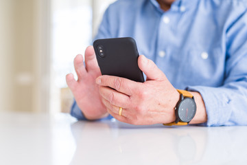 Close up of man hands using smartphone over white table