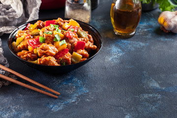 Sweet and sour chicken with colorful bell pepper on a plate