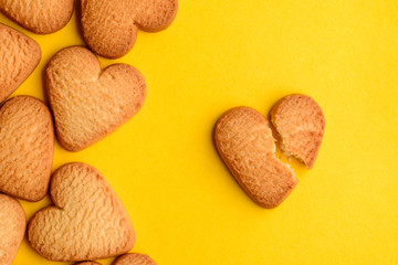 Heart-shaped cookies on yellow background